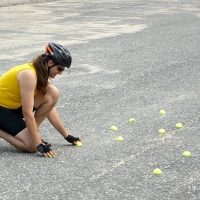 BikeSkillsB6_060715 Halves of tennis balls make a visible and safe obstacle course. Here, they create a narrow path, to practice zig-zagging around a pothole without changing course.