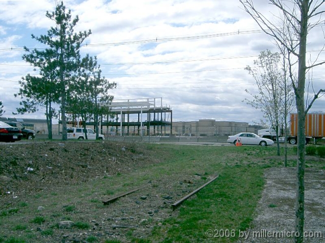 060417SpeenStCrossingToNatickMall Looking back uphill, across Speen Street to the growing Neiman Marcus store at Natick Mall (April 2006). This is a likely place for a future separated-grade crossing.
