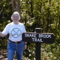 010905CSPCRTshirt PART 4 - Snake Brook Trail.
CRT activist Jill Miller shows off a CRT-shirt -- and one of Cochituate State Park's 