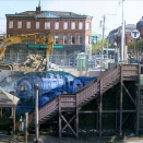 050511NatickRRStaPan PART 1 - Downtown Natick, Commuter Rail and Bicycle Parking.
The Natick Center Commuter Rail Station, with downtown Natick just beyond the Walnut Street pedestrian bridge and with the start of the CRT at extreme right. The 2001 mural celebrates Natick's 350th anniversary with various scenes from its past.
This panorama view is spliced from three photographs. To maximize (Zoom) it, tap your keyboard's 