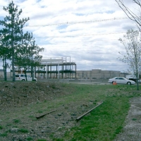 060417SpeenStCrossingToNatickMall Looking back uphill, across Speen Street to the growing Neiman Marcus store at Natick Mall (April 2006). This is a likely place for a future separated-grade crossing.