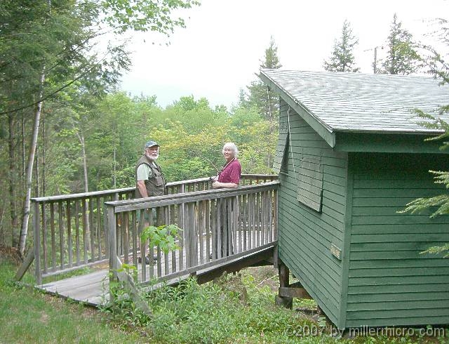 070601ColdRiverCamp_BernieAndJillAtACabin We arrived ahead of the crowd, so we looked over a few of the cabins. Many of them, like this one, perch over a ravine.