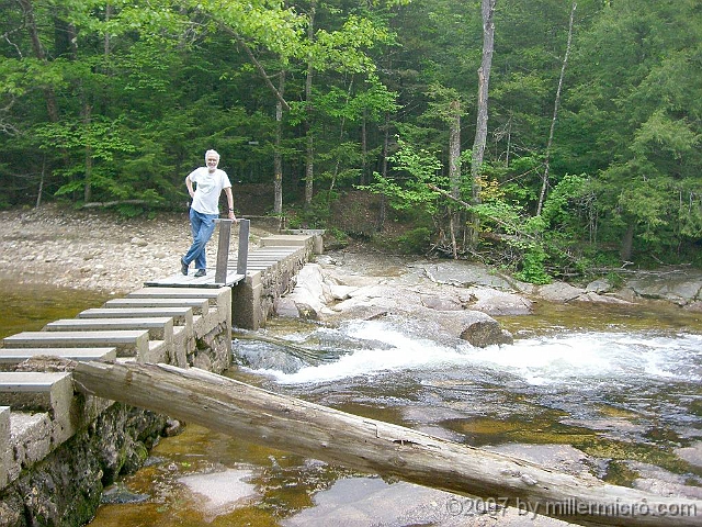 070601ColdRiverCamp_DickOnDam_1024 ..this dam. When closed, it creates a nice swimming hole just upstream. This log hints that there's a lot more water during spring runoff.
<br>
(Photo by Jill Miller)
