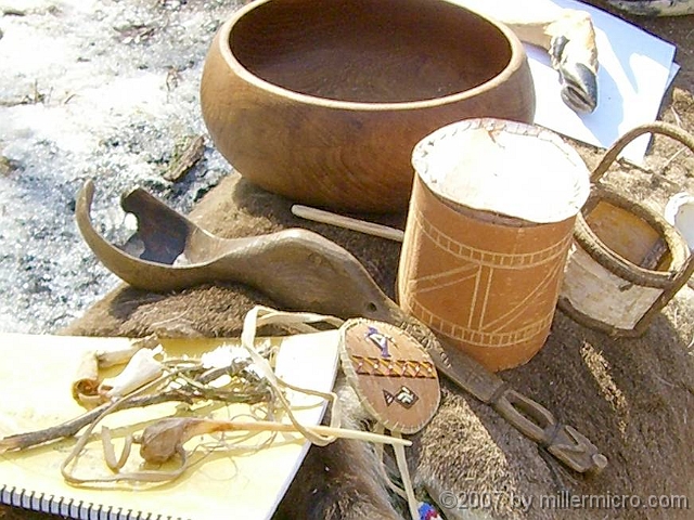 070303WampanoagSpoonEtAl2 an ancient ladle! You can see its now-broken bowl on the left, and its handle on the right. The handle has a man carved into its end, with his legs slightly bowed so it can be hung up. But what's in the middle of this well-crafted ladle? Why, it's a duck's head, bill and all!