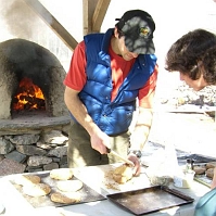 070303BeehiveOven1 an outdoor, beehive oven! As you might guess, this bread is made of whole wheat and is very good!