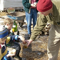 070303SyrupingColonialStyle3 And then, everyone enjoyed a taste sample of the partly-evaporated syrup, made Colonial-style.