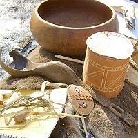 070303WampanoagSpoonEtAl2 an ancient ladle! You can see its now-broken bowl on the left, and its handle on the right. The handle has a man carved into its end, with his legs slightly bowed so it can be hung up. But what's in the middle of this well-crafted ladle? Why, it's a duck's head, bill and all!