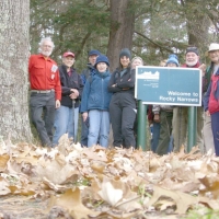 061026RockyNarrows2 All eleven hikers pose at the canoe landing on the Charles River.