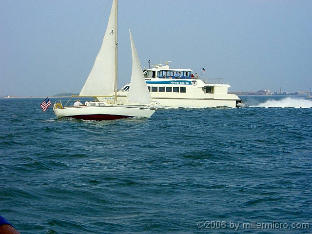 060727SpectacleIsland18 Mixing fun with business. Behind the sailboat, an MBTA (