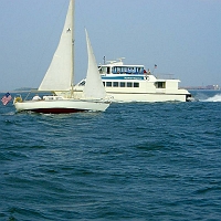 060727SpectacleIsland18 Mixing fun with business. Behind the sailboat, an MBTA (